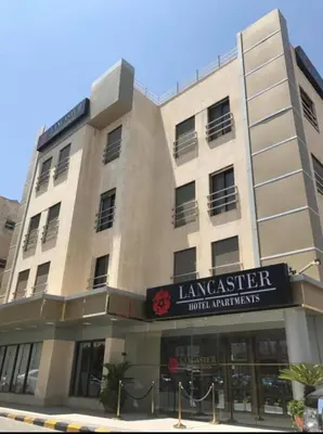 a building with a sign that reads lancaster hotel apartments at LANCASTER HOTEL APARTMENTS DAHIET ALRASHEED in Amman