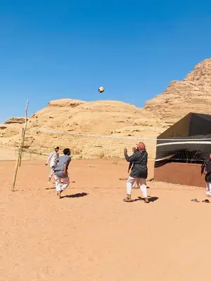 a group of people playing with a ball in the desert at Enjoy Wadi Rum stars in Disah