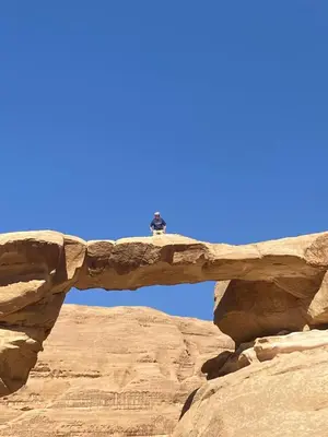 a view through a stone arch in the desert at Enjoy Wadi Rum stars in Disah