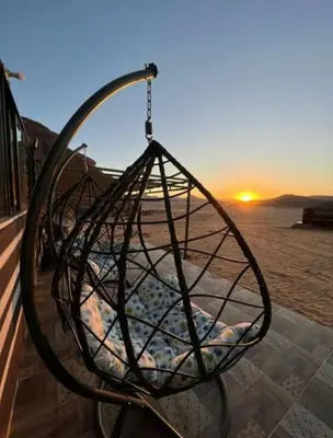 a metal sculpture of a ball on the beach at Enjoy Wadi Rum stars in Disah