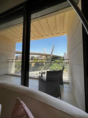 a view of a balcony from a room with a window at The bridge Residence in Amman