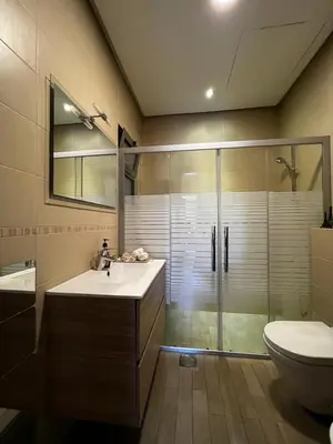 a bathroom with a shower and a sink and a toilet at The bridge Residence in Amman