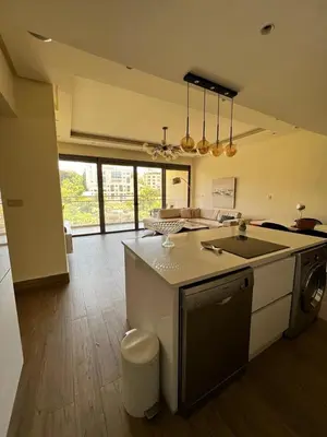 a kitchen with a sink and a stove top oven at The bridge Residence in Amman