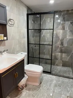 a bathroom with a shower and a toilet and a sink at Jori Luxury Camp in Wadi Rum