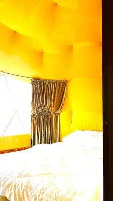 a yellow room with a bed with a window at Jori Luxury Camp in Wadi Rum
