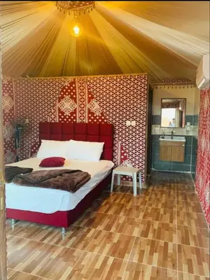 a bedroom with a large bed in a tent at Jori Luxury Camp in Wadi Rum