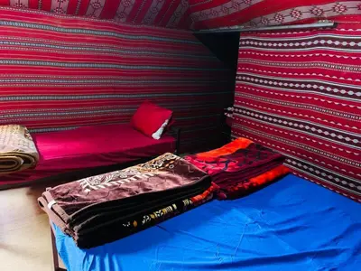 a small room with a bed and a couch at Awad Bedouin camp in Wadi Rum