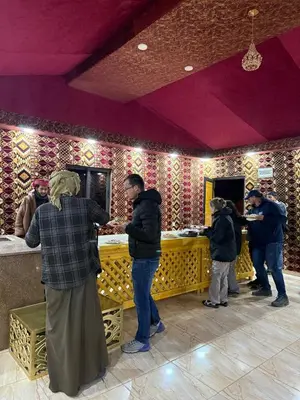 a group of people standing in front of a counter at Desert Nights Camp in Wadi Rum