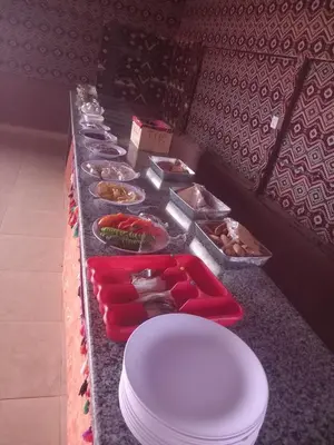 a buffet line with plates and bowls of food at Desert Nights Camp in Wadi Rum