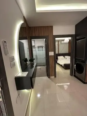 a room with a bedroom with a bed and a mirror at modern apartment in abdoun-amman in Amman