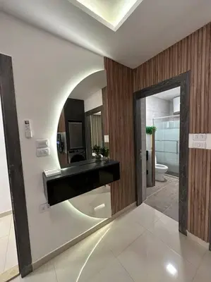 a bathroom with a sink and a toilet and a mirror at modern apartment in abdoun-amman in Amman