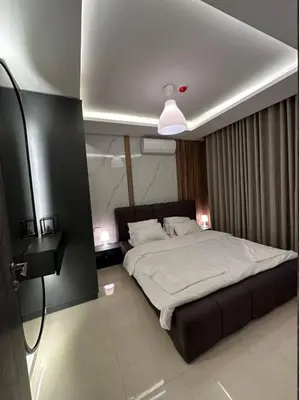 a bedroom with a large bed in a room at modern apartment in abdoun-amman in Amman