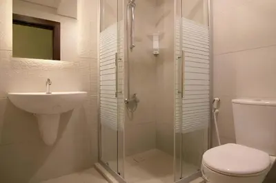 a bathroom with a shower and a sink and a toilet at 46 Serviced Apartments in Amman