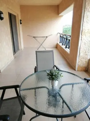 a glass table and chairs in a room at Dead Sea Jordan Sea View Samarah Resort Traveler Award 2024 winner in Sowayma