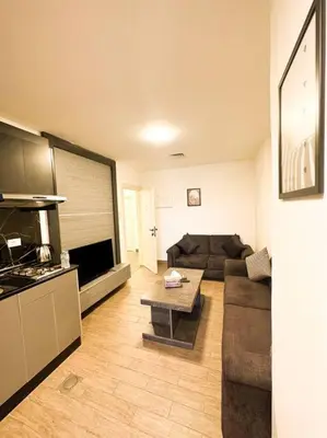 a living room with a couch and a table at central apartment for rent 29 in Umm Uthainah