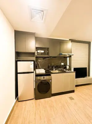 a kitchen with a stove and a refrigerator at central apartment for rent 29 in Umm Uthainah