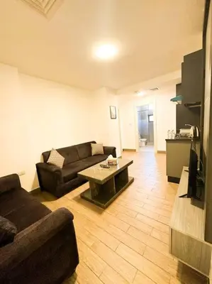 a living room with a couch and a table at central apartment for rent 29 in Umm Uthainah