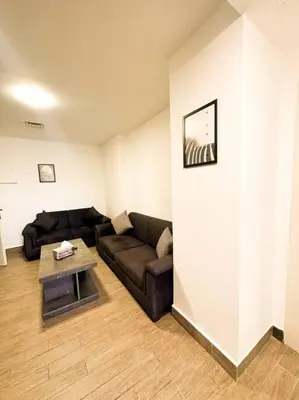 a living room with a couch and a table at central apartment for rent 29 in Umm Uthainah