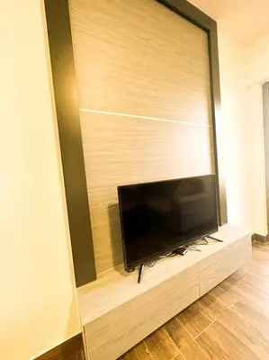 a flat screen tv sitting on a wall at central apartment for rent 28 in Umm Uthainah