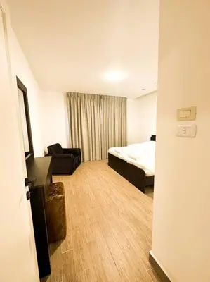 a hotel room with a bed and a couch at central apartment for rent 26 in Umm Uthainah