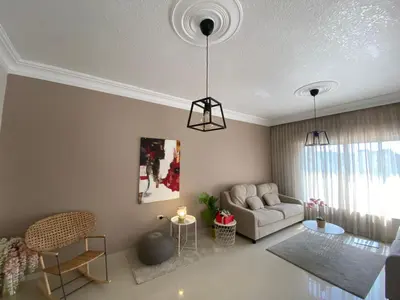 a living room with a couch and a table at Modern chic haven in Amman