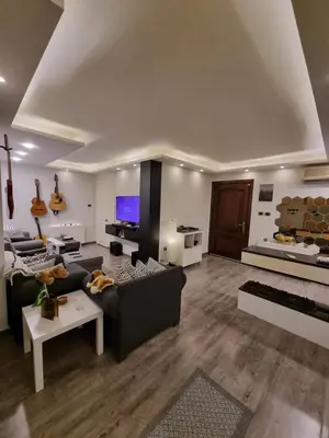a living room with two couches and a tv at MK3 - Two Bedroom Apartment in Amman