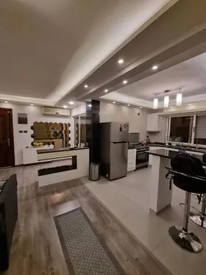 a large kitchen with a refrigerator and a stove at MK3 - Two Bedroom Apartment in Amman