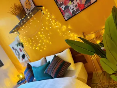 a bedroom with a bed with lights on the wall at Medusa Home Stay in Amman
