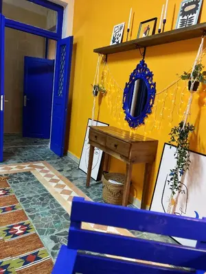 a room with a blue bench and a blue door at Medusa Home Stay in Amman