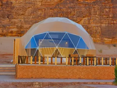 a domed building with a blue dome in the desert at Wadi rum Rozana camp in Wadi Rum
