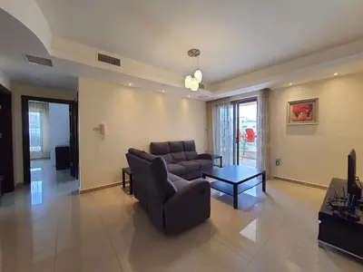 a living room with a couch and a table at Abdoun Panorama in Amman