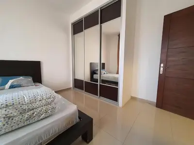 a bedroom with a bed and a large mirror at Abdoun Panorama in Amman