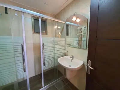 a bathroom with a sink and a shower at Abdoun Panorama in Amman