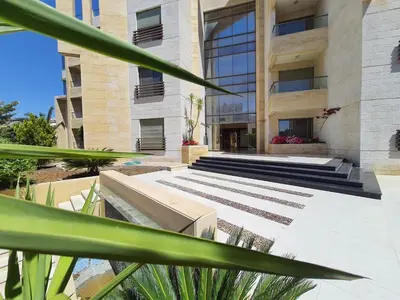 a building with stairs in front of a building at Abdoun Panorama in Amman