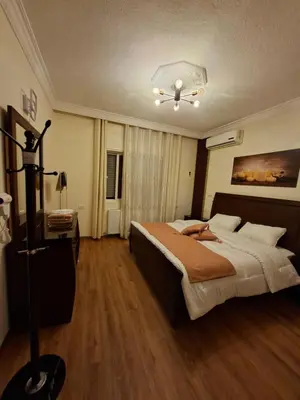 a bedroom with a large bed in a room at Shafa Badran Families Apt in Amman