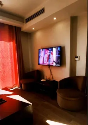 a living room with a flat screen tv on the wall at Seven stars hotel apartment in Amman