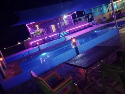a house with a swimming pool at night at shalyh tal birin in Şarrūt
