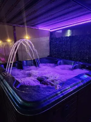 a hot tub with purple lights in a room at shalyh tal birin in Şarrūt