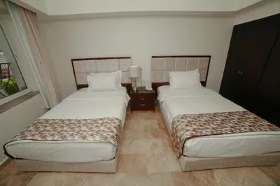 two beds in a hotel room with two beds sidx sidx sidx at Yafko Hotel in Aqaba