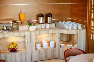 a wooden counter with cups and drinks on it at Yafko Hotel in Aqaba