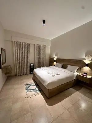 a bedroom with a large white bed in a room at Alraha VIP Marsa zayed Aqaba in Aqaba