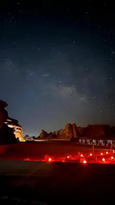 a night time view of a beach with a starry sky at Rum Under The Stars Camp in Wadi Rum