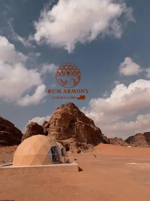 a dome in the desert with a sign that reads run arrows luxury camp at Armony rum camp in Wadi Rum