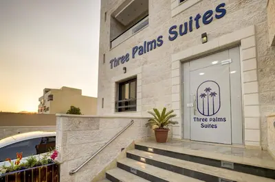 a three palms suites building with stairs in front at Three Palms Suites in Aqaba