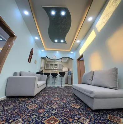 a living room with two couches and a kitchen at Treasure of Petra in Wadi Musa