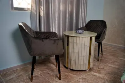 two chairs and a table in a room at Treasure of Petra in Wadi Musa