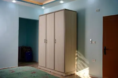 a bedroom with a large wooden cabinet in a room at Treasure of Petra in Wadi Musa