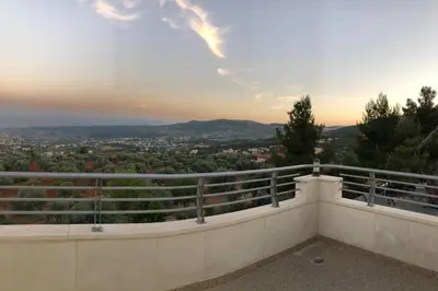 a view of the city from the balcony of a house at The Pine Tree Chalet in Jerash