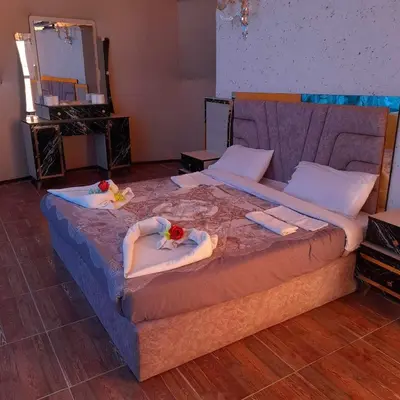 a large bed with towels and flowers on it at Sami Al Muzna Rum Camp in Wadi Rum