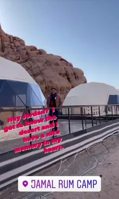 a man standing next to a bus with pink shoes on it at Sami Al Muzna Rum Camp in Wadi Rum